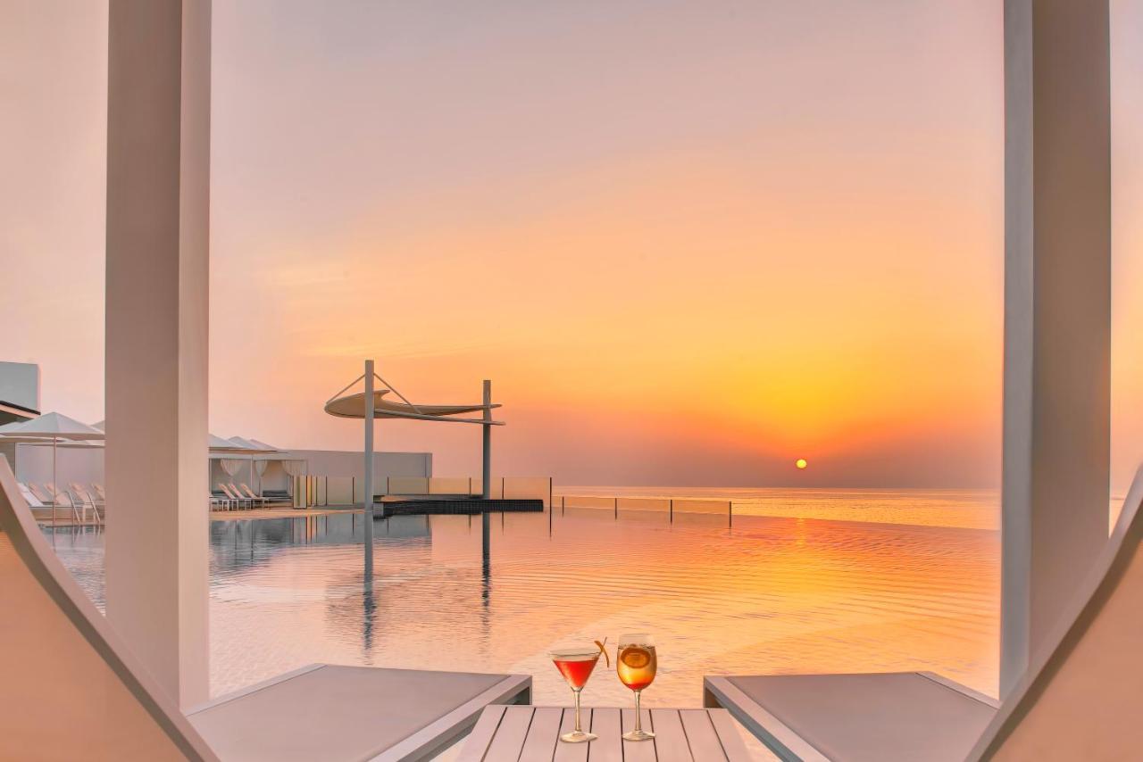 Royal M Al Aqah Beach Resort By Gewan Exterior foto Sunset at the pool